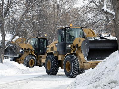 snow plows on a winnipeg city street
