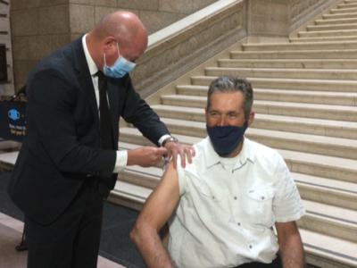 imagine showing Dr. Brent Roussin, Manitoba's chief medical officer of health, giving former Premier Brian Pallister the COVID-19 booster