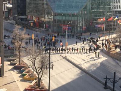 protesters participating in a round dance at Winnipeg's Portage and Main intersection