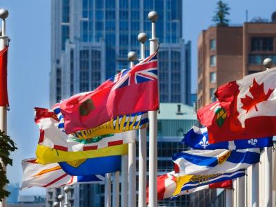 manitoba and canada flags waving near other provincial flags 
