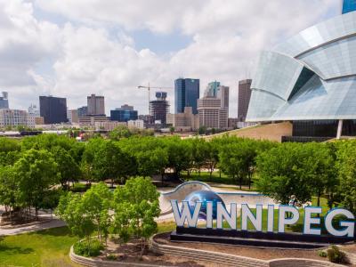 a view of the Winnipeg skyline, including the "Winnipeg" sign at the Forks